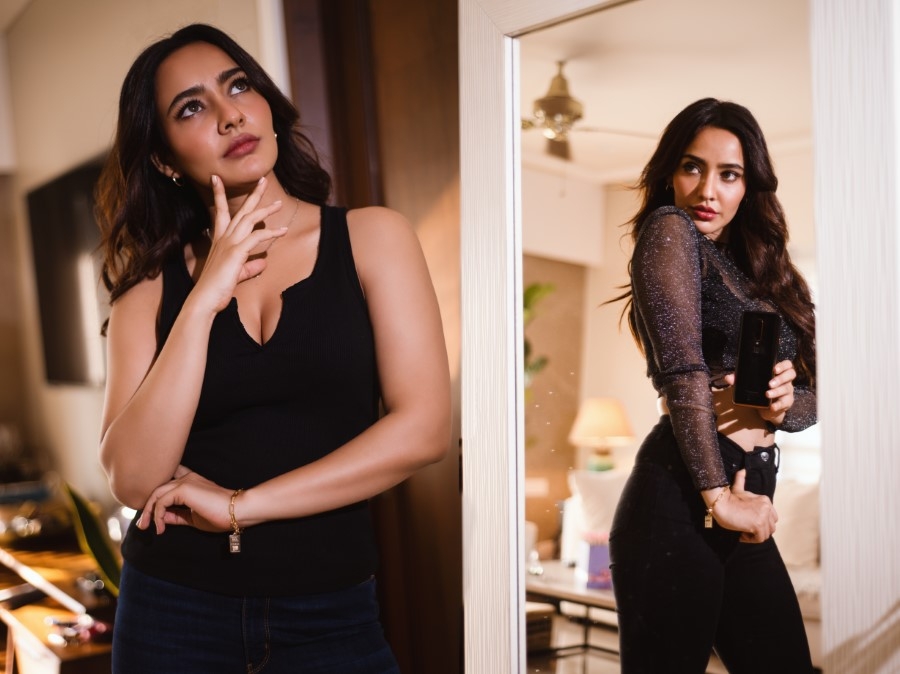 Neha Sharma in black posing for OnePlus 7T Pro Mclaren edition influencer campaign