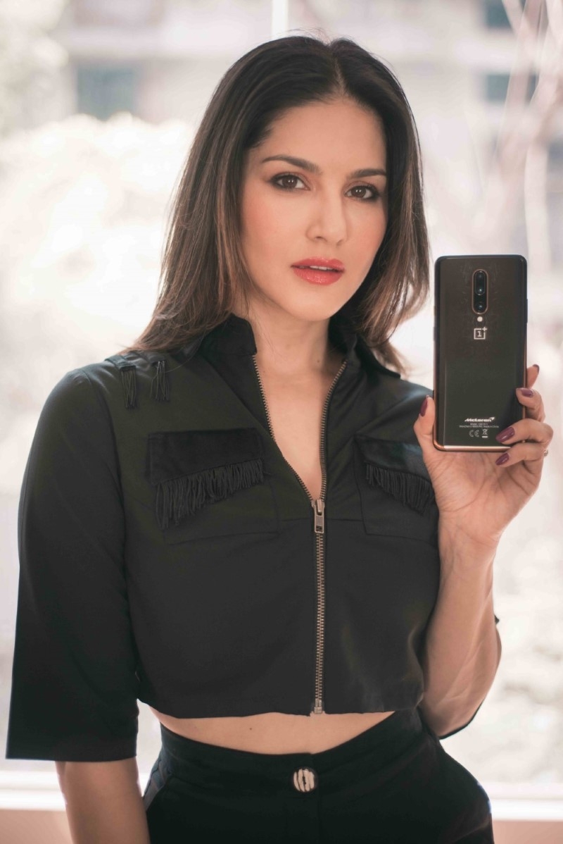 Sunny Leone in black posing for OnePlus 7T Pro Mclaren edition influencer campaign