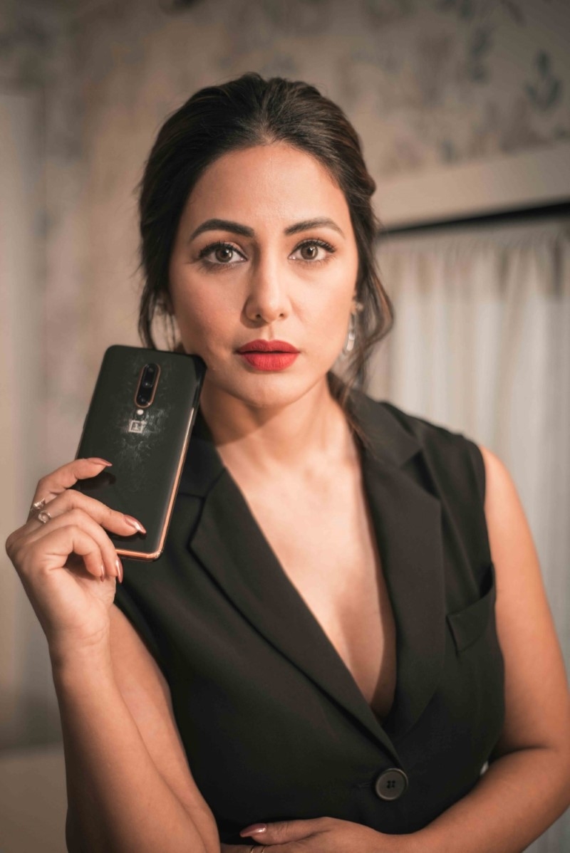 Heena Khan in black posing for OnePlus 7T Pro Mclaren edition influencer campaign