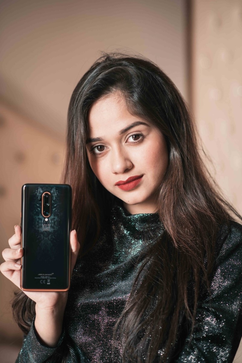 Jannat Zubair Rahmani in black posing for OnePlus 7T Pro Mclaren edition influencer campaign