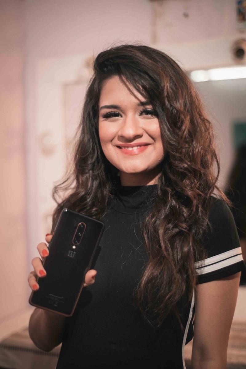 Avneet Kaur in black posing for OnePlus 7T Pro Mclaren edition influencer campaign