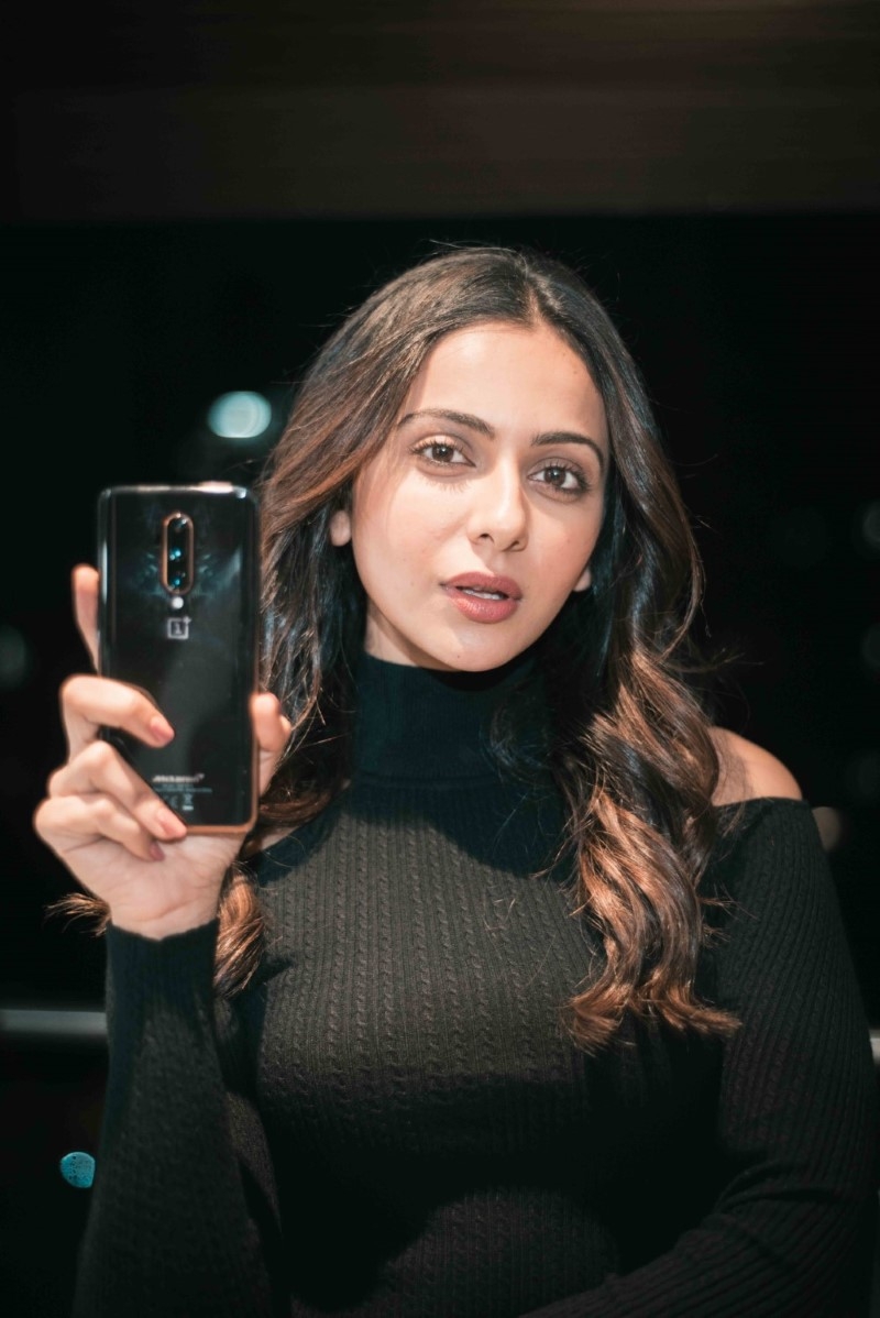 Rakul Preet Singh in black posing for OnePlus 7T Pro Mclaren edition influencer campaign